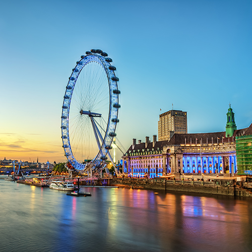 The London Eye on the South Bank of the River Thames at night in London, England.